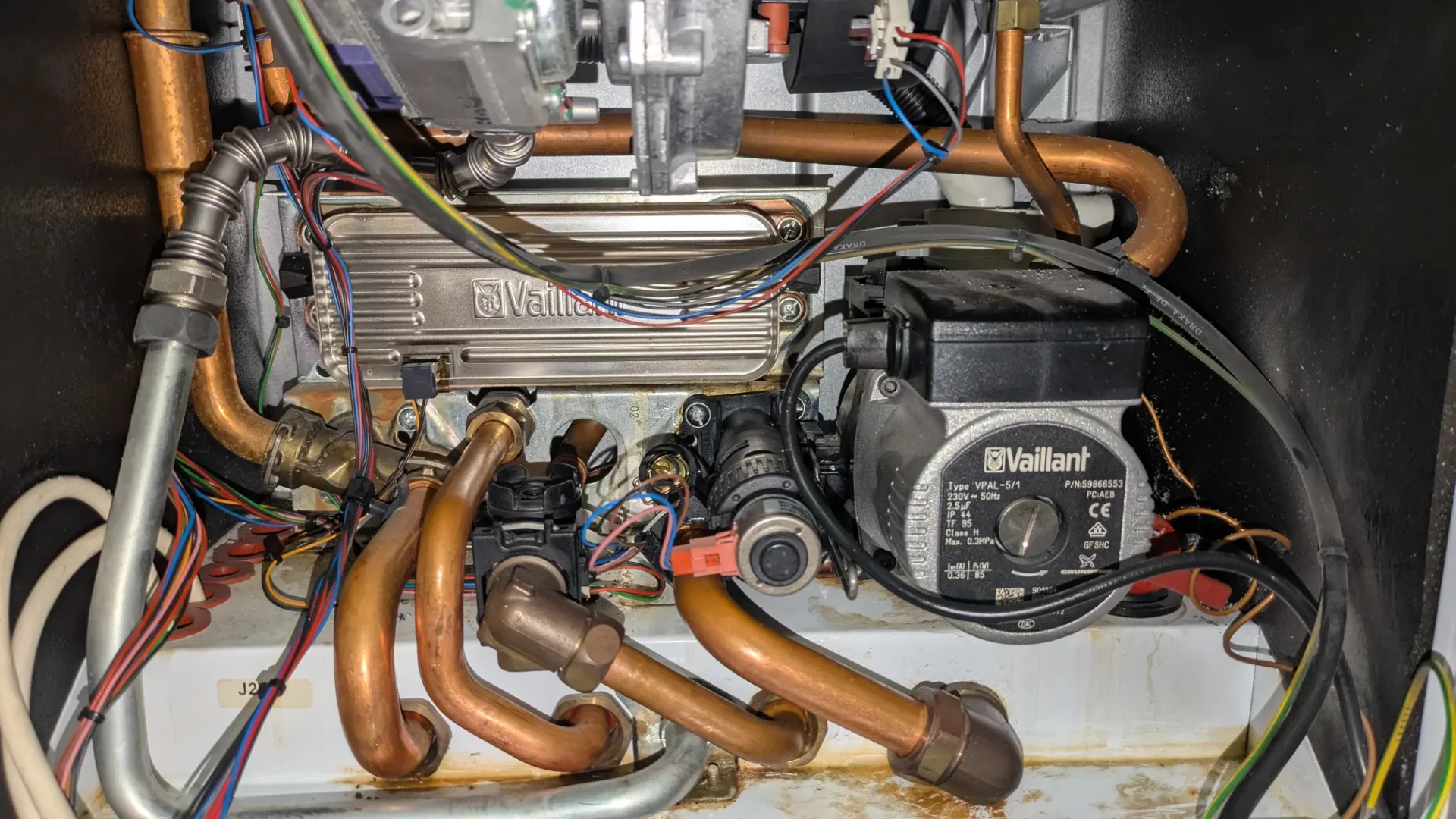 Wall-mounted boiler with its casing removed for servicing