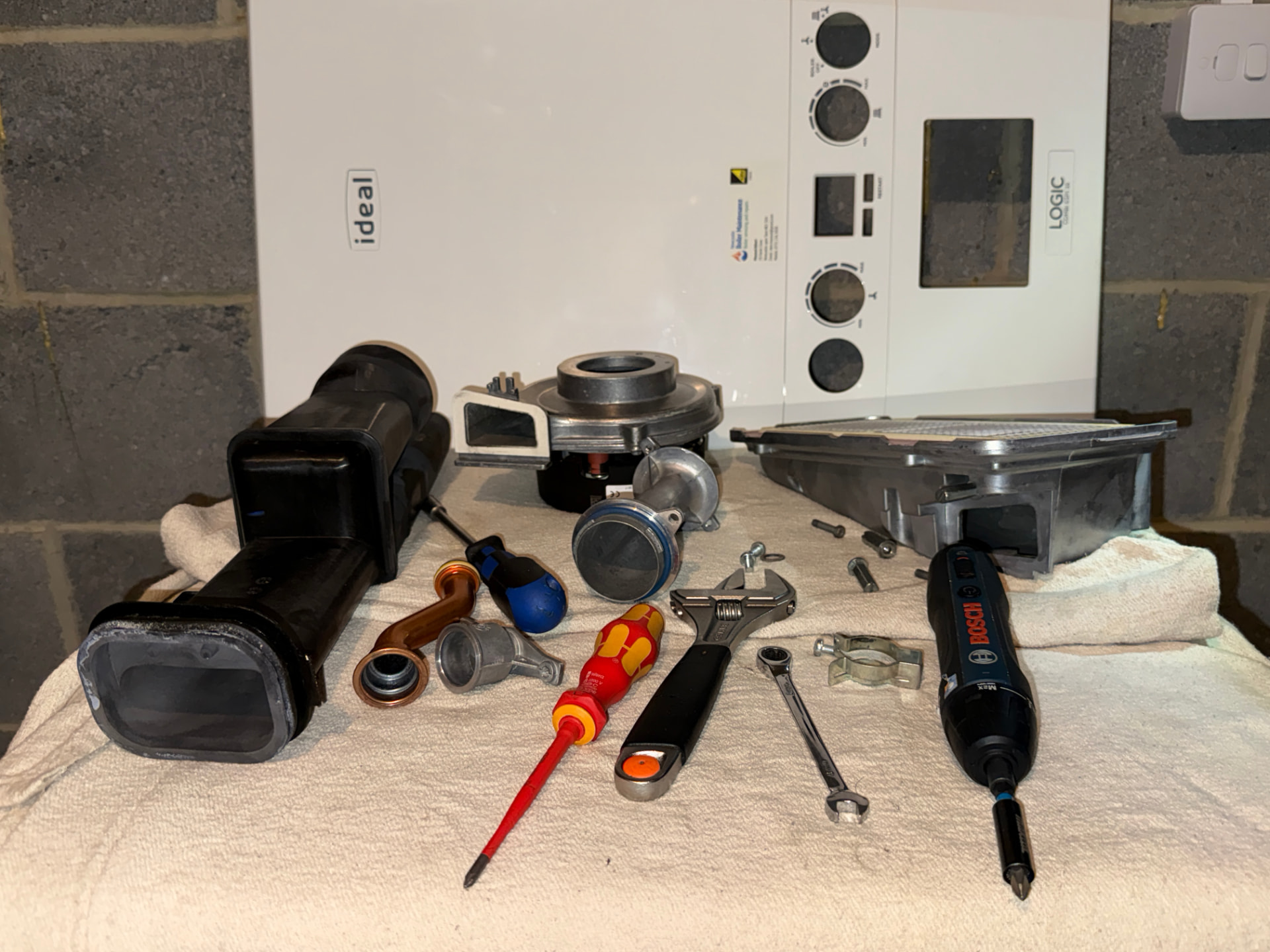 Domestic boiler with servicing tools laid out on the worktop