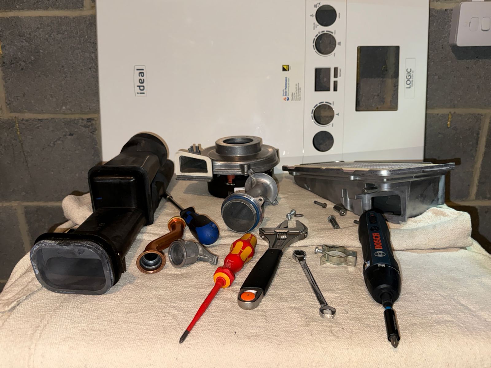 Boiler parts and engineer's tools laid out ready for a boiler repair by a Gas Safe registered engineer in Newcastle upon Tyne