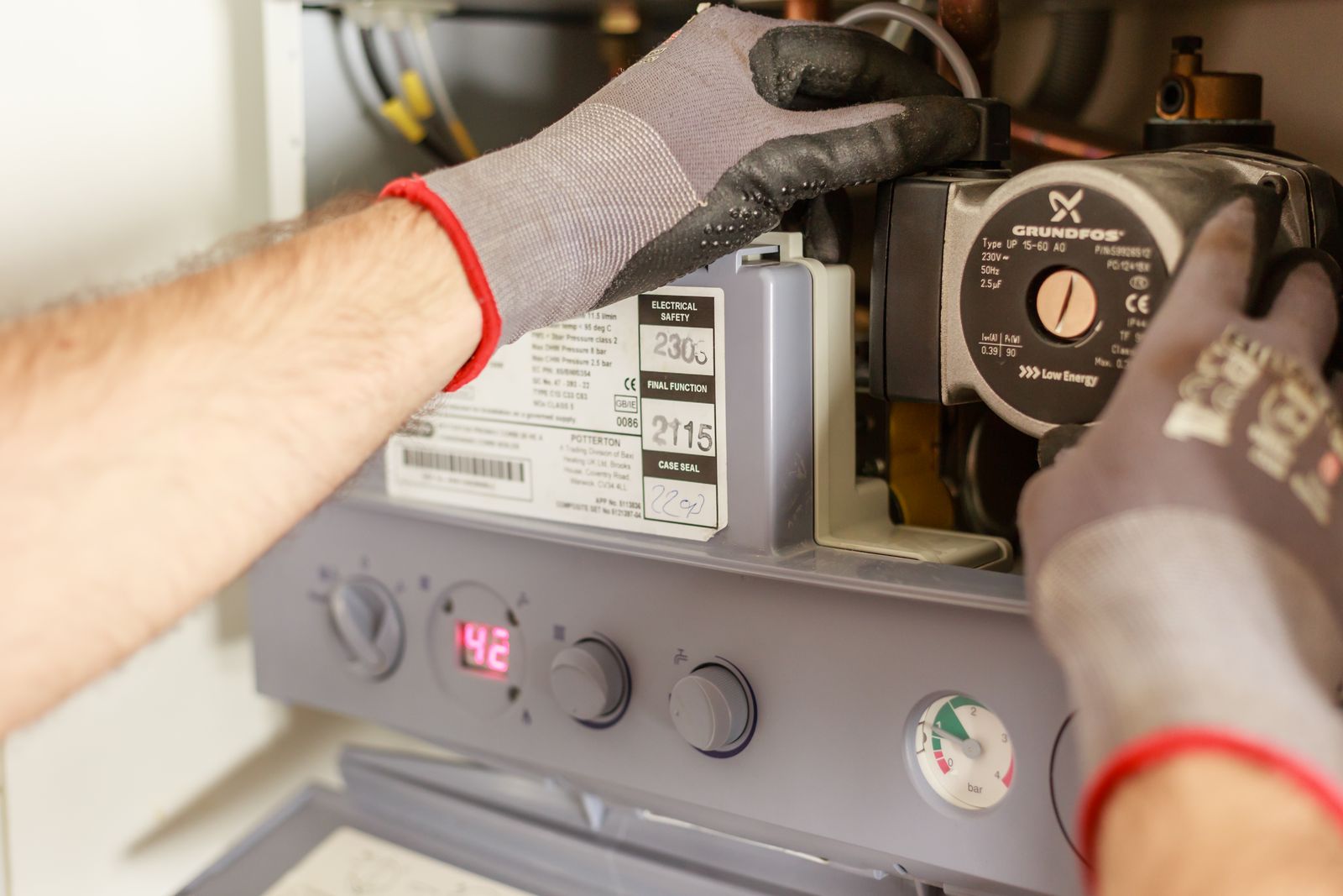 Heating engineer carrying out maintenance work on a home heating system